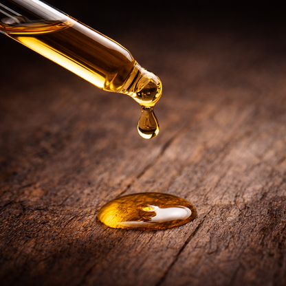Hub City Bourbon Beard Oil, golden oil droplet on textured wood